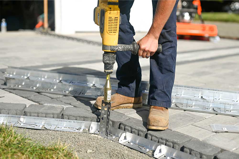 Installing Hybrid HD Edge Restraint in open grade application with Hybrid HD Stake and Quick-E-Hammer