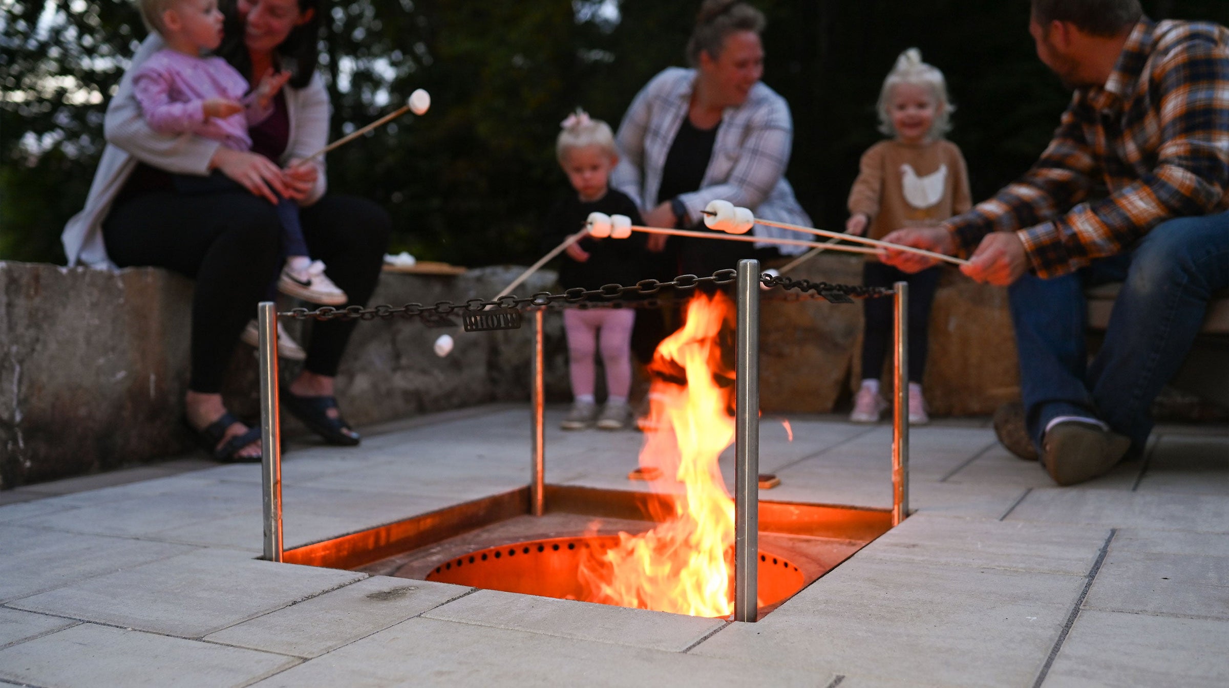 photo of family roasting smore's around a fire pit