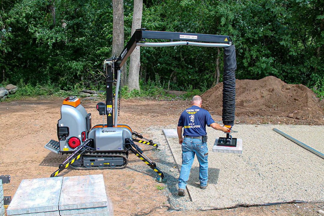 Person operating Allrounder on a construction site with trees in the background