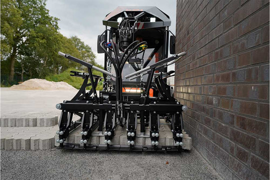 An orange and black S24 PaveJet paver laying machine laying pavers